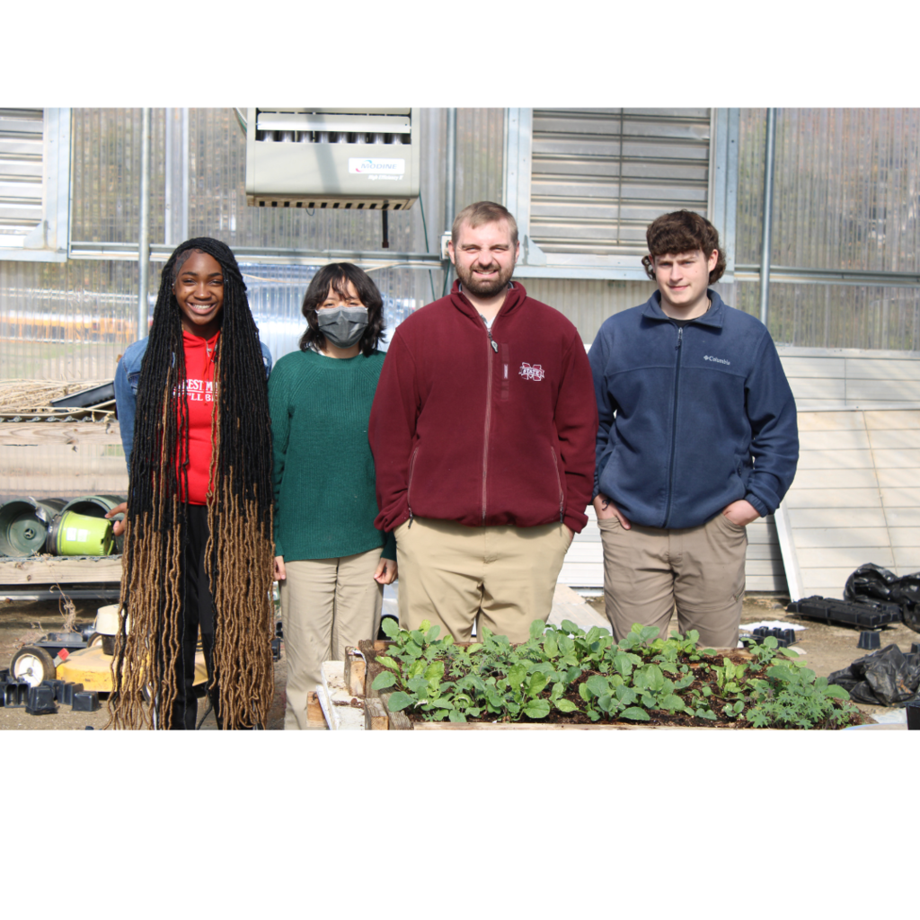 ANR students standing with Mr. Perry outside the greenhouse.
