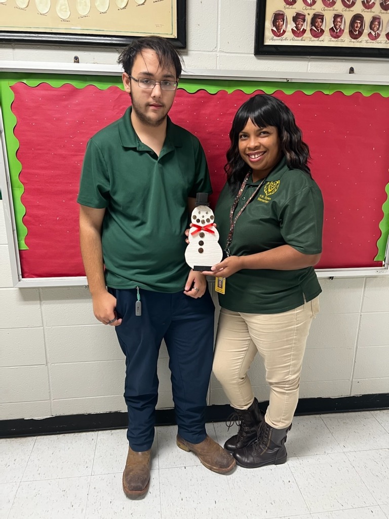 Ms. Knight and student posing with homemade snowman gift. 