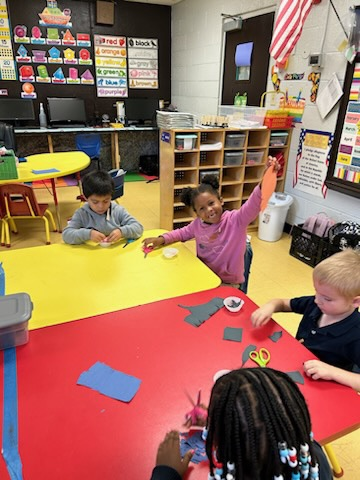 kinder students cutting paper